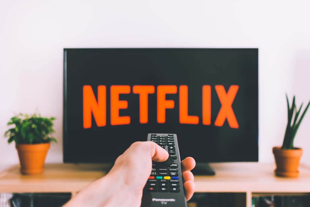 how to unblock iptv on at&t internet — person holding remote pointing at TV